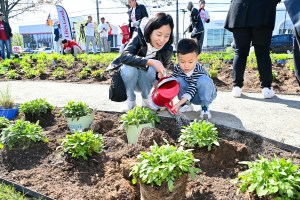 Attendees plant native species at the new pollinator garden at LG's Life's Good Earth Day Community Fair.