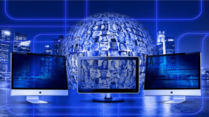 computer screens in front of a world globe