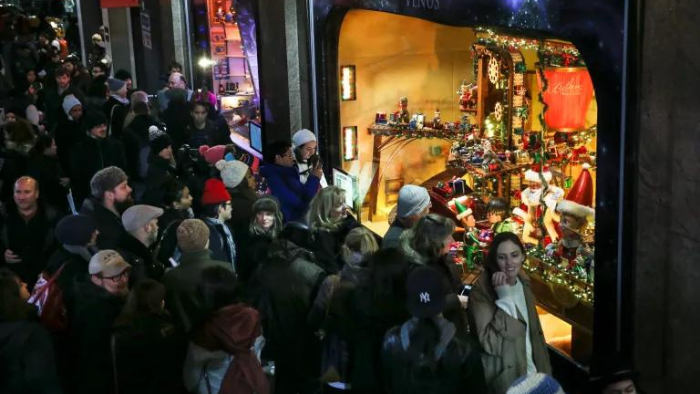 Shoppers gathered outside Macy's holiday window display