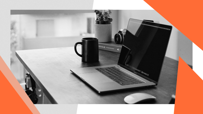 Steps to Set up a Targeted Newsfeed - Laptop and coffee mug on a desk near a window