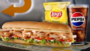 Subway sandwich with a Pepsi and Lay's chips