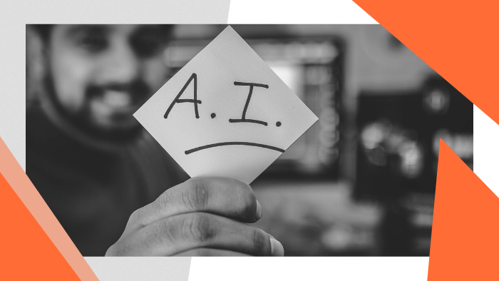 Man holding up a piece of paper that reads "AI"