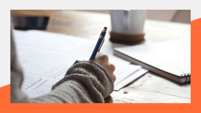 Back to School Items for Journalism Students - Person writing in a notebook on a desk with coffee mug