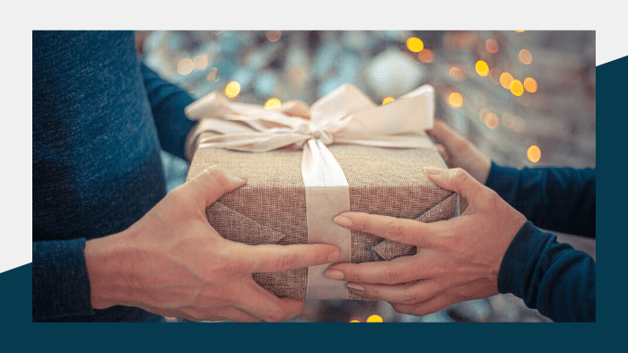 2022 Holiday Gift Guide - two people exchanging a gift