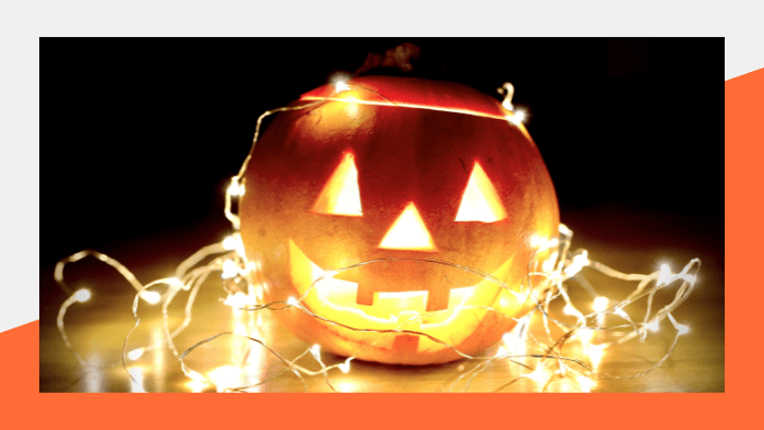 Jack-o-latern surrounded by twinkle lights - Beyond Bylines Halloween Blogs