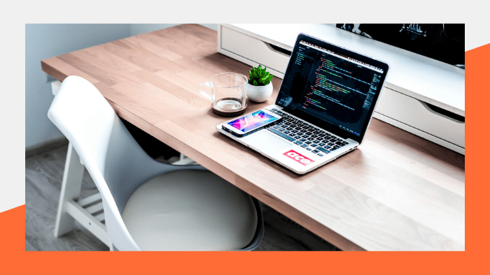 a laptop on a table with coding on the screen