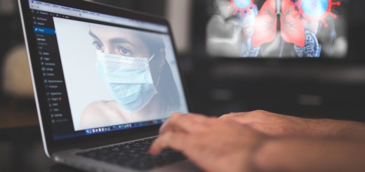 laptop with image of woman with mask on the screen