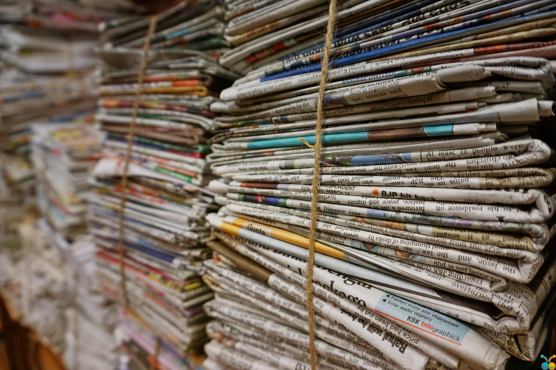 Stacks of newspapers tied together with rope