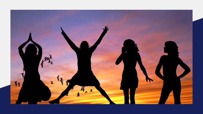 Four women silhouetted against a sunset