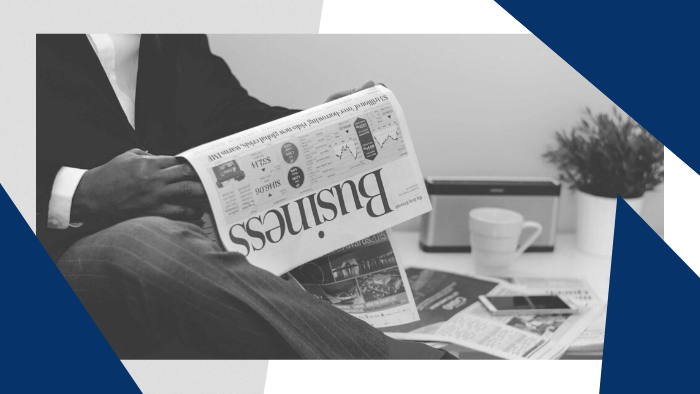 Man reading the Business section of a newspaper