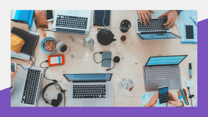 Media Insider, May 5, 2023 - People sitting around a table with laptops, phones and other tech