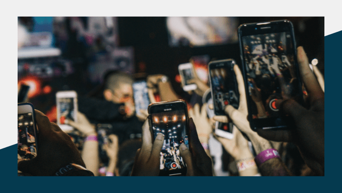 Crowd capturing video on their smartphones